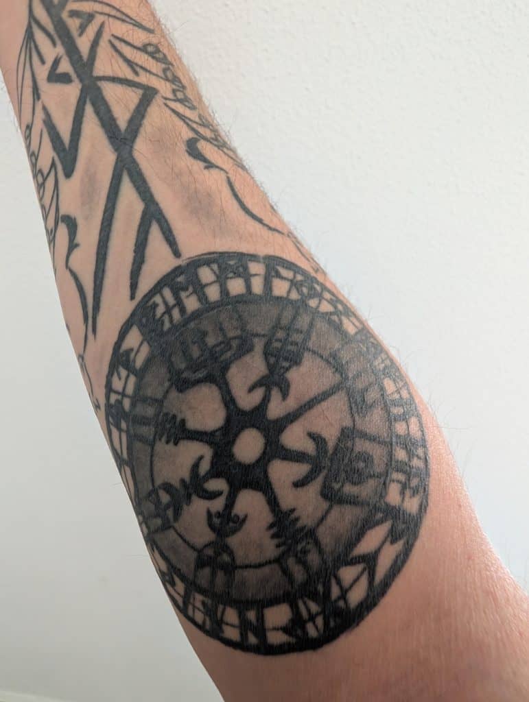Close-up of a vegvisir tattoo on a forearm, part of a larger tattoo honoring the Norse goddess Freyja