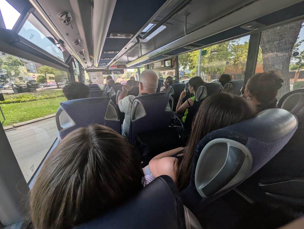 Crowded bus interior to Los Santos de la Humosa.